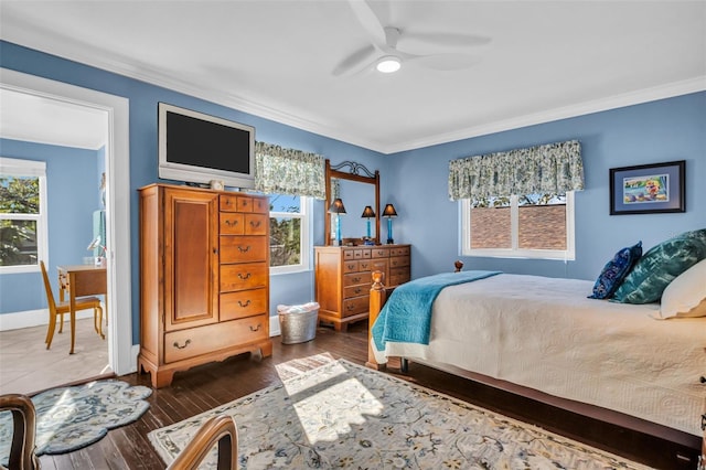 bedroom with ornamental molding, dark wood finished floors, a ceiling fan, and baseboards