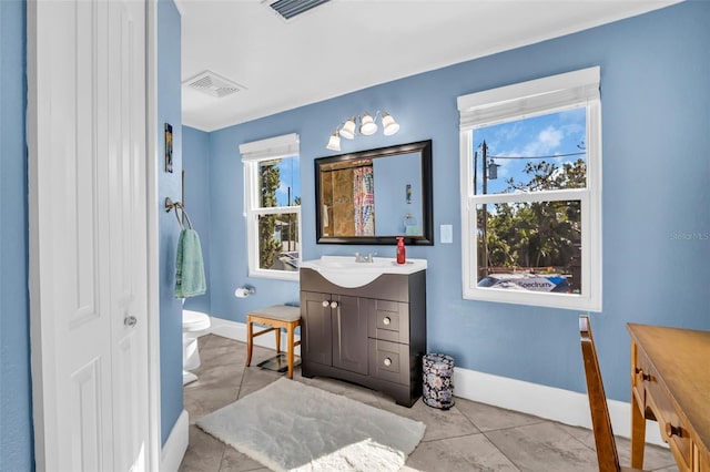 bathroom with toilet, vanity, visible vents, baseboards, and a closet