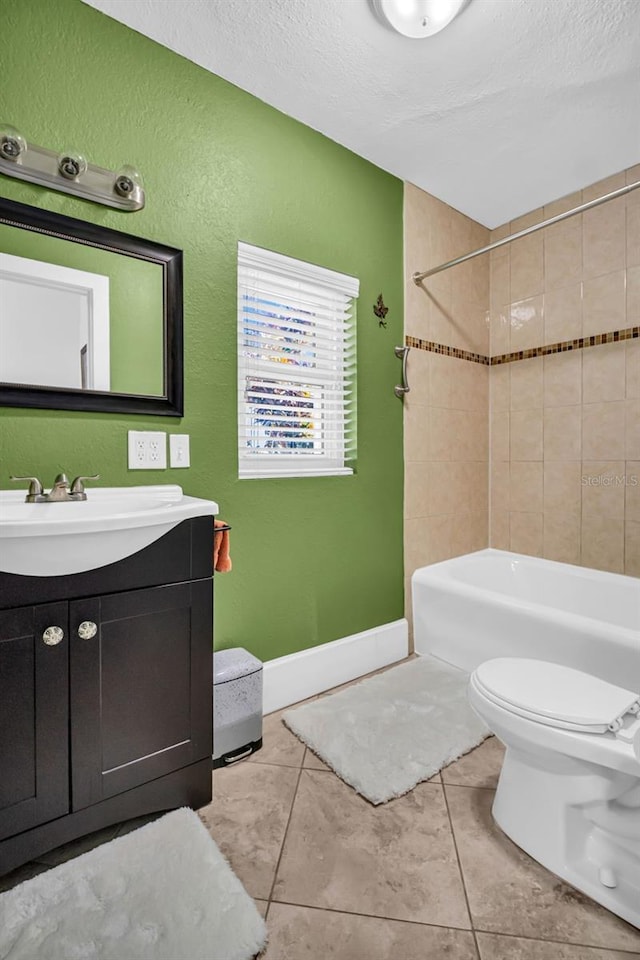 full bathroom with tile patterned floors, toilet, a textured ceiling, vanity, and tiled shower / bath combo