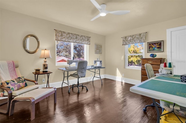 office area with a healthy amount of sunlight, a ceiling fan, baseboards, and wood finished floors