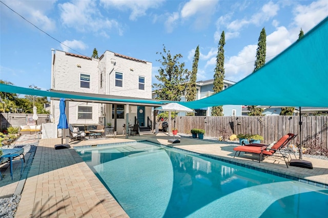 view of pool featuring a patio area, a fenced backyard, and a fenced in pool