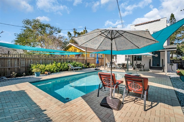 view of swimming pool featuring a patio, a fenced backyard, and a fenced in pool