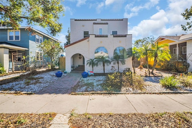 mediterranean / spanish-style house with a balcony and stucco siding