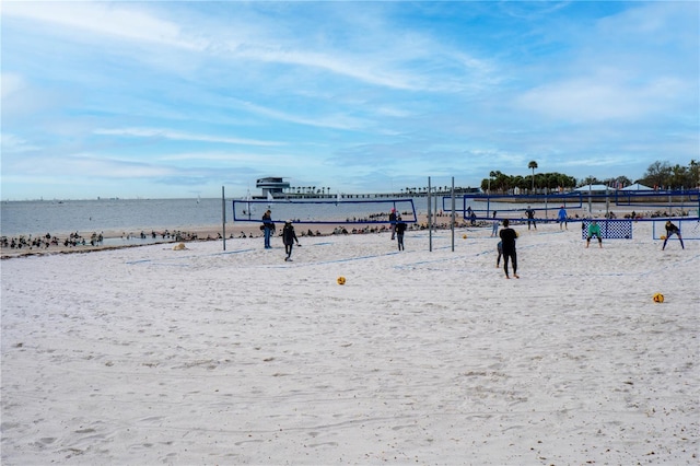 view of property's community with a water view and a view of the beach