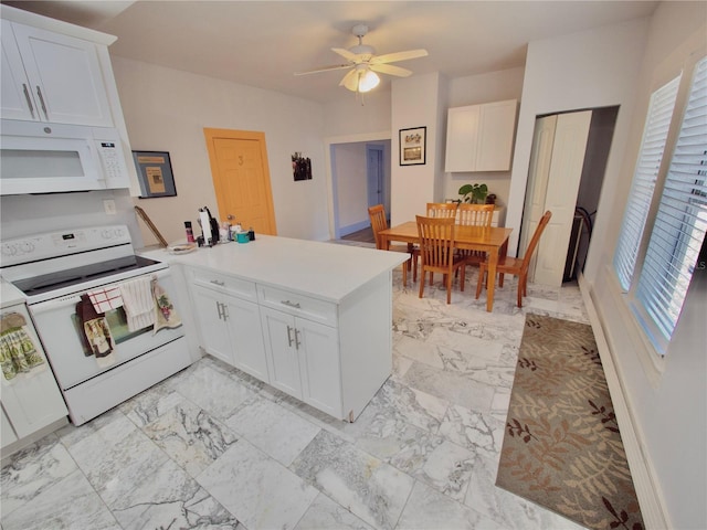 kitchen with white cabinetry, white appliances, and kitchen peninsula