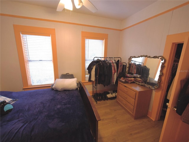 bedroom with multiple windows, ceiling fan, and light hardwood / wood-style flooring