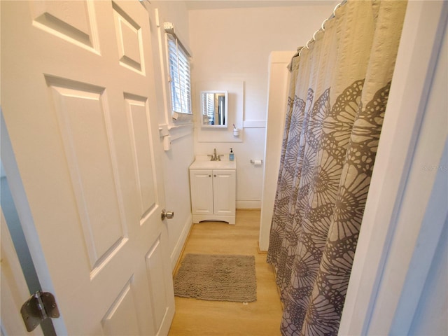 bathroom featuring hardwood / wood-style flooring and vanity