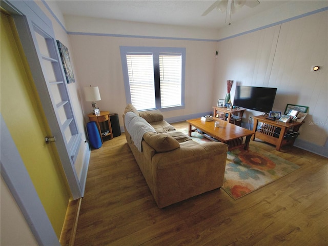 living room featuring wood-type flooring and ceiling fan