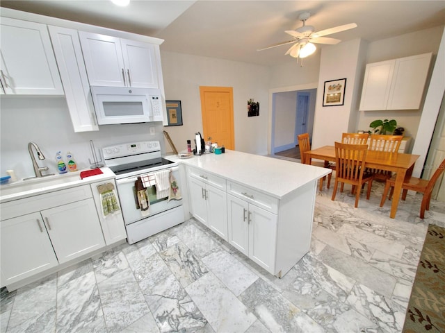 kitchen featuring white cabinetry, sink, white appliances, and kitchen peninsula