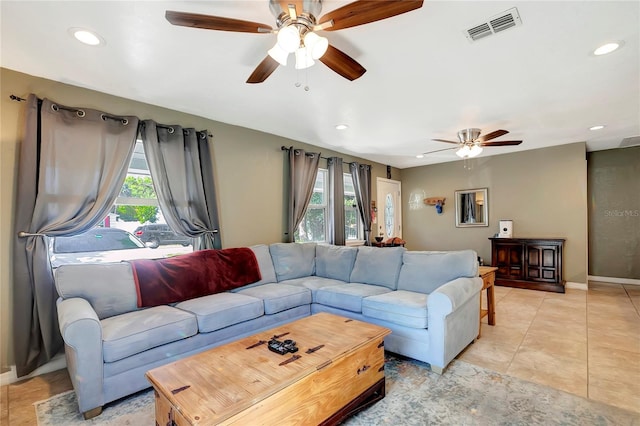 living room with plenty of natural light, light tile patterned floors, and ceiling fan