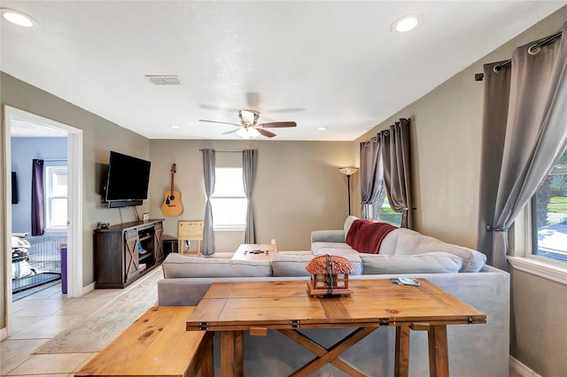 living room with ceiling fan and light tile patterned flooring