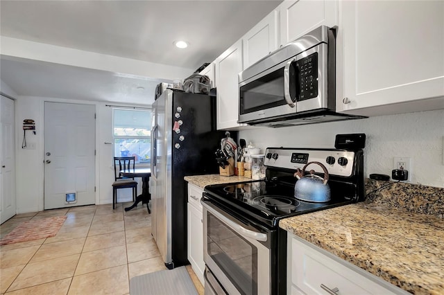 kitchen featuring white cabinetry, appliances with stainless steel finishes, light stone countertops, and light tile patterned flooring