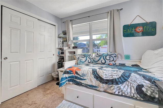 bedroom with light carpet and a closet