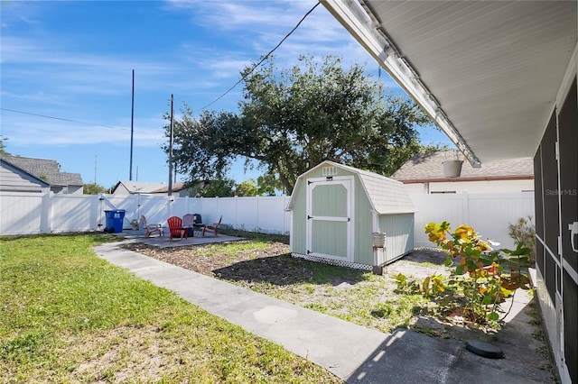 view of yard featuring a storage shed and a patio