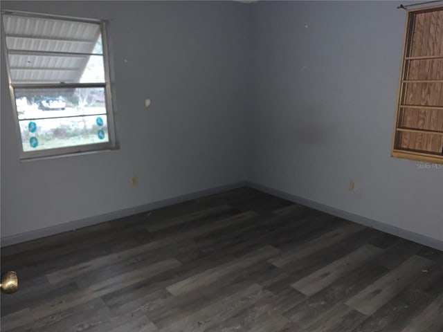 empty room featuring dark hardwood / wood-style flooring