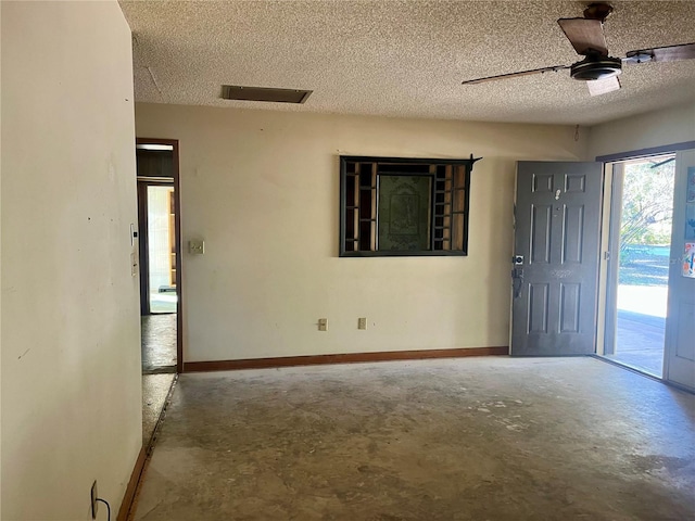 empty room with concrete flooring, a textured ceiling, and ceiling fan