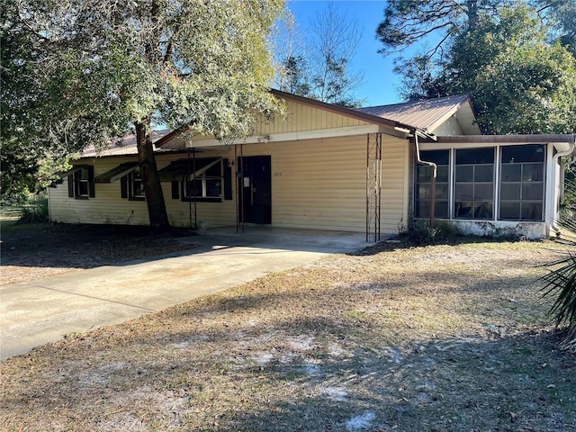 ranch-style house with a sunroom and a carport