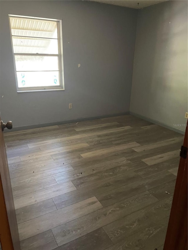 spare room with hardwood / wood-style floors