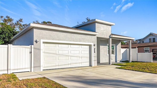 view of front of house featuring a garage and a front lawn