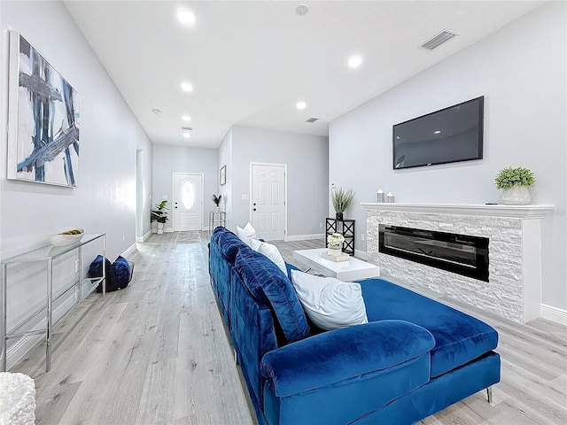 living room featuring a fireplace and light hardwood / wood-style flooring