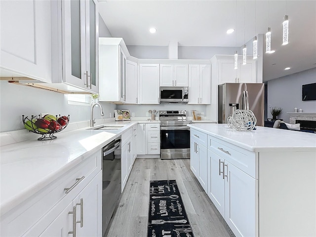 kitchen with sink, white cabinets, and appliances with stainless steel finishes