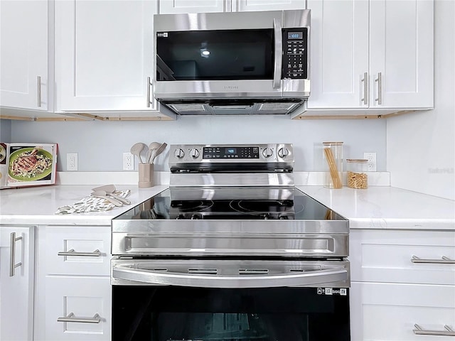 kitchen featuring stainless steel appliances and white cabinets