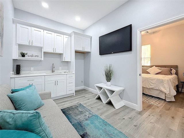 living room with sink and light hardwood / wood-style flooring