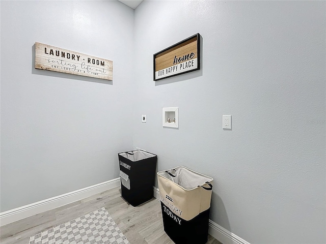 clothes washing area featuring hookup for a washing machine, electric dryer hookup, and light hardwood / wood-style floors