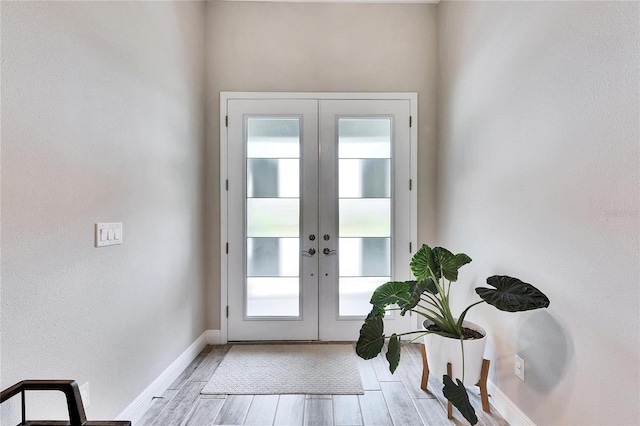 entryway featuring french doors and light hardwood / wood-style flooring