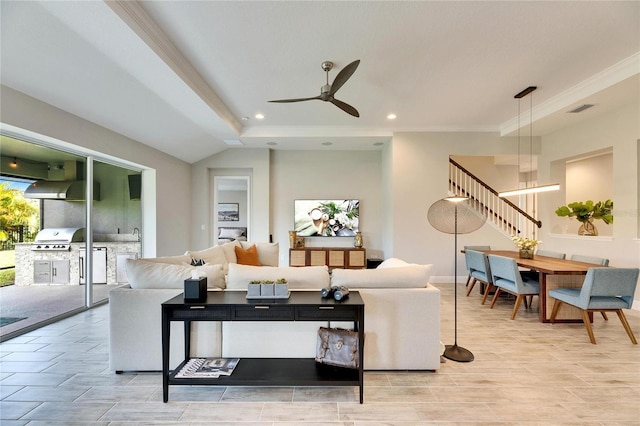 living room featuring ceiling fan and ornamental molding