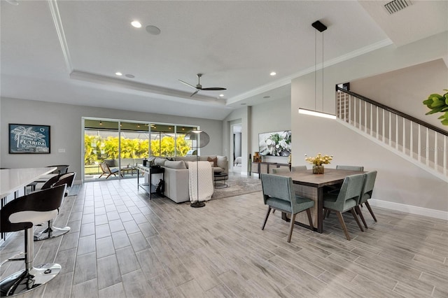 dining room featuring ornamental molding, ceiling fan, and a tray ceiling