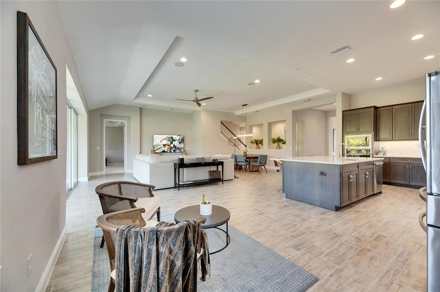 living room featuring ceiling fan and sink