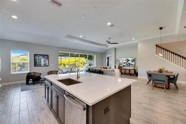 kitchen featuring an island with sink, plenty of natural light, sink, and stainless steel dishwasher