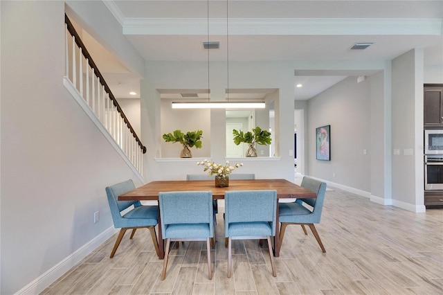 dining space with crown molding