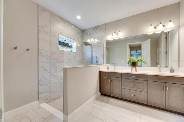 bathroom featuring tiled shower and vanity