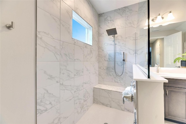 bathroom with vanity and tiled shower