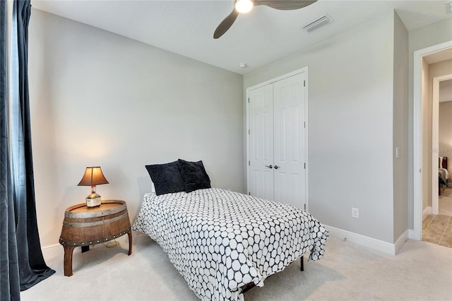 carpeted bedroom with ceiling fan and a closet