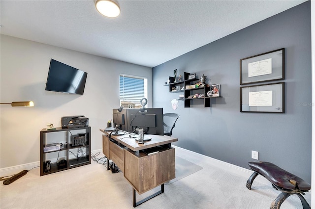 home office featuring light colored carpet and a textured ceiling