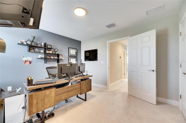 office area featuring light colored carpet and a textured ceiling