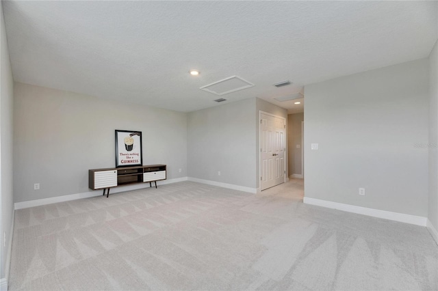 carpeted spare room with a textured ceiling