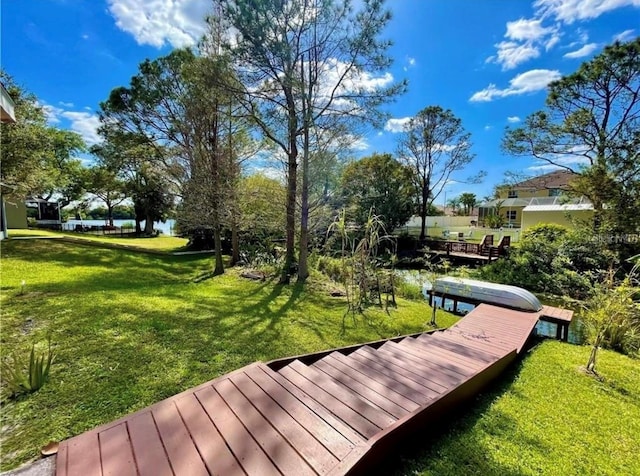 view of community featuring a water view and a lawn