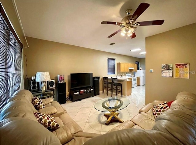 tiled living room featuring ceiling fan