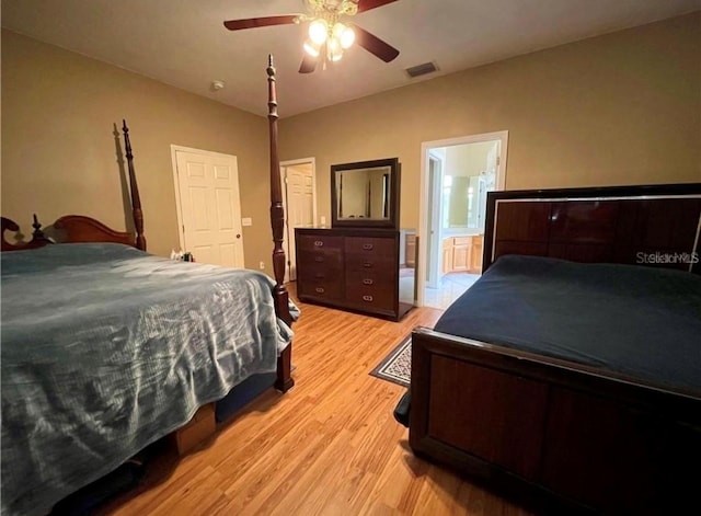 bedroom featuring ensuite bathroom, light wood-type flooring, and ceiling fan