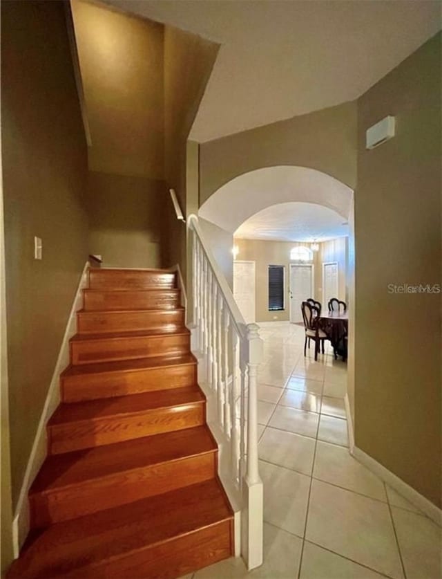 stairway featuring tile patterned flooring