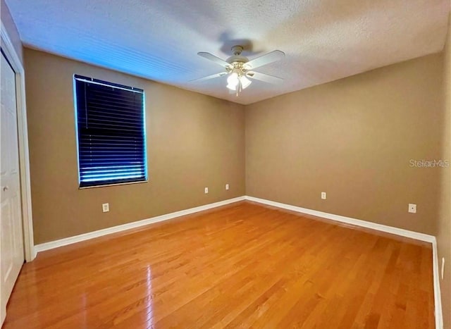 unfurnished room featuring a textured ceiling, ceiling fan, and hardwood / wood-style flooring