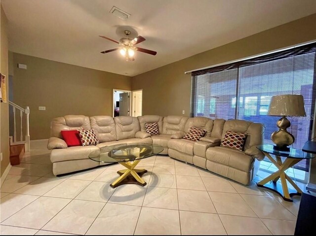 living room with ceiling fan and light tile patterned floors