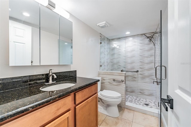 full bathroom with visible vents, toilet, tile patterned floors, vanity, and a shower stall