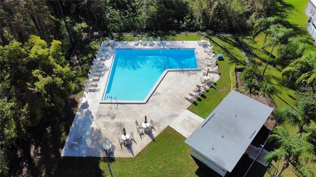 community pool featuring a patio area and a lawn