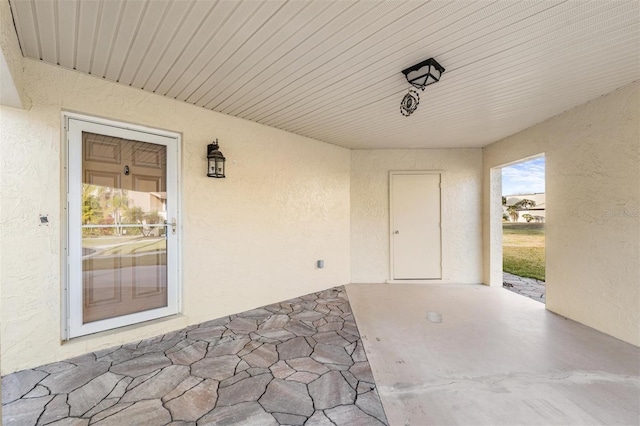 doorway to property featuring a patio and stucco siding