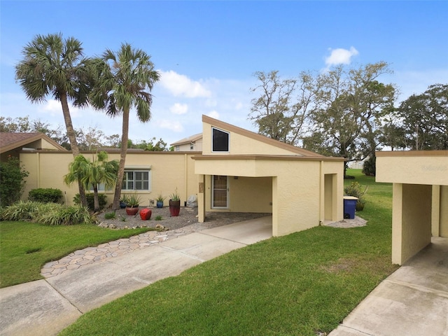 view of front of home featuring a front lawn and stucco siding